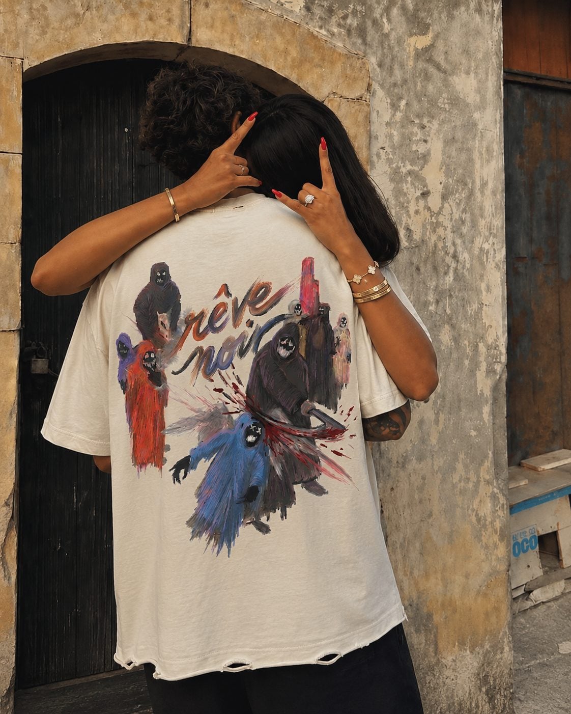 Friends & Foes tee, shot under a stone arch